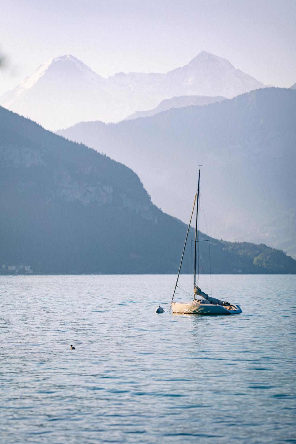 sailing yacht with mountains in the background